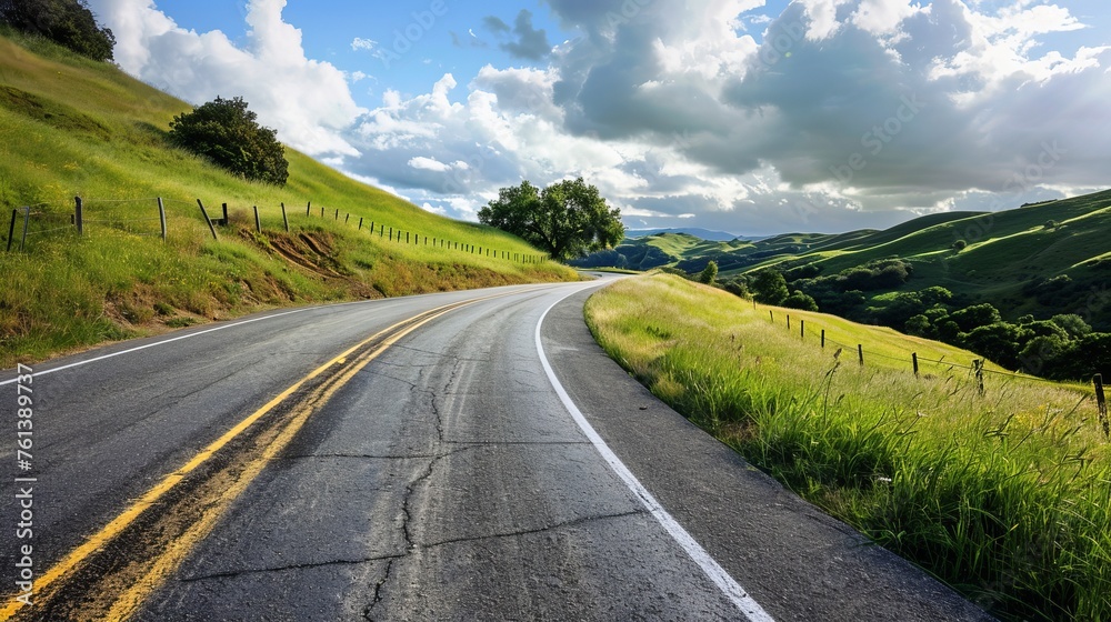 Naklejka premium An open road through rolling hills, inviting a summer road trip. 