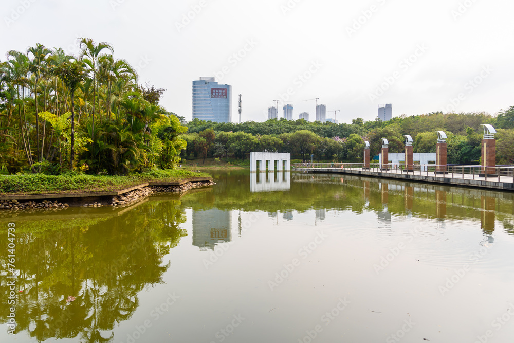 Spring scenery at Yuanmei Park in Dongguan, China. A tranquil lake is surrounded by lush trees.
Spring scenery at Yuanmei Park in Dongguan, China. A tranquil lake is surrounded by lush trees.