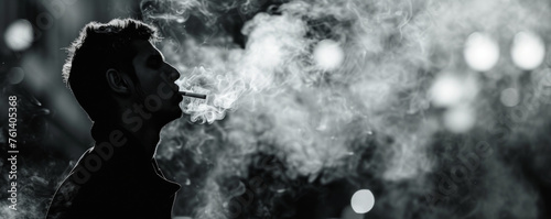 Man smokes a cigarette and lets smoke out of his mouth. Long dark banner
