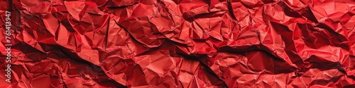 Close-up shot of a vibrant red crumpled paper texture background, adding depth and character to any design.