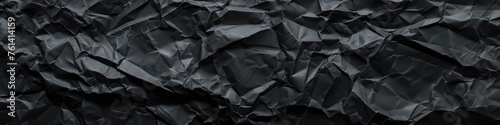 Uncover the allure of a single-colored crumpled paper texture background, rendered in deep black, offering a timeless elegance to your designs. photo