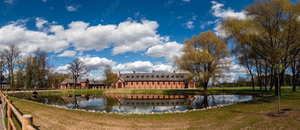 Panoramic view of Zagare manor stables on a sunny spring day, Lithuania