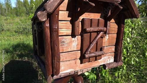 Little wooden hut on chicken legs on a green background summer nature. photo