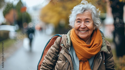 An elegant senior woman with silver hair radiates joy as she takes a leisurely walk
