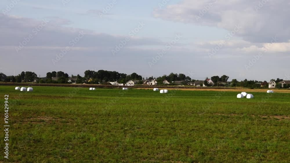 Haystacks in white material. Rural nature. Harvest. Haystacks in white material. Rural nature. Harvest.