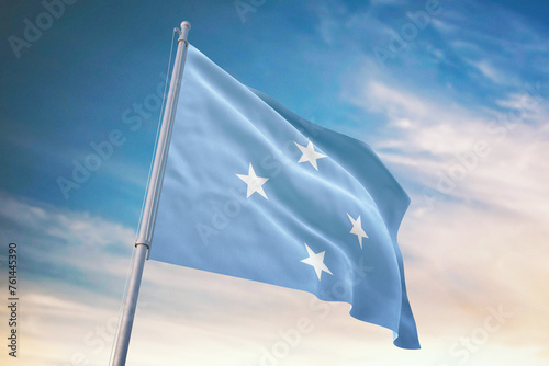 Waving flag of Micronesia in blue sky. Micronesia flag for independence day. The symbol of the state on wavy fabric.