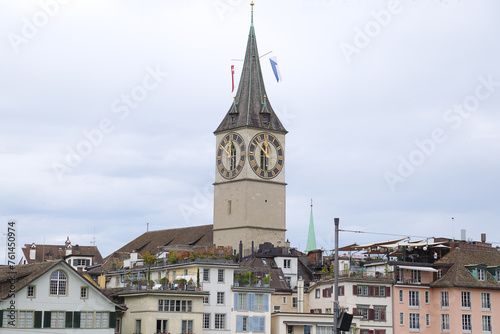 View of the historic city center with famous Saint Peter, on the Limmat river. Zurich, Switzerland.