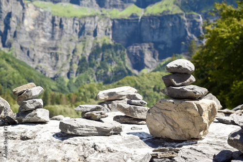 Stack of balancing rocks symbolising peace and mindfulness over a lush mountain landscape