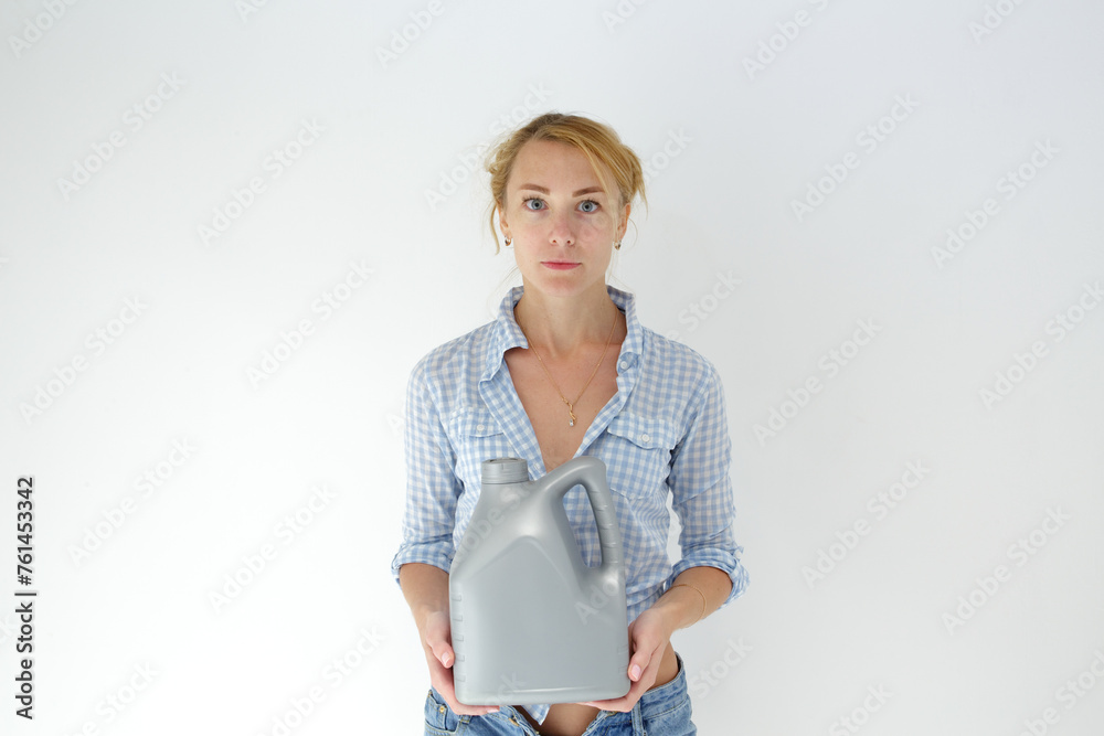 Smiling woman holding detergent bottle for machine wash. Isolated studio portrait on white.