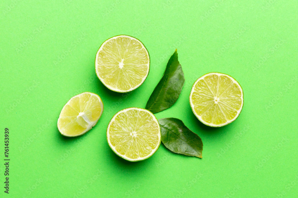 Lime fruits with green leaf and cut in half slice isolated on white background. Top view. Flat lay with copy space Lime fruits with green leaf and cut in half slice isolated on white background. Top view. Flat lay with copy space