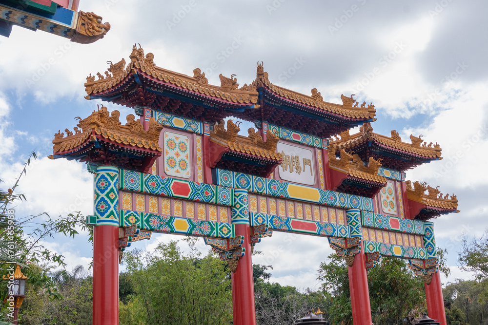 Chinese temple wall with carved figures and arches with cloudy sky Chinese temple wall with carved figures and arches with cloudy sky