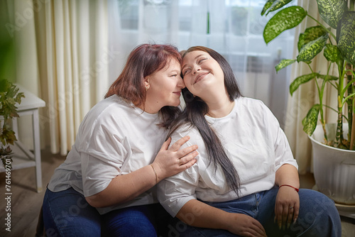 Happy Overweight family with mother and daughter in room. Middle aged woman and teenager girl having fun, joy, hugging