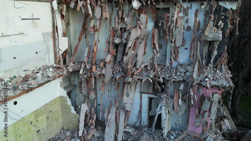 Drone aerial view of gutted and destroyed building with collapsed balconies and windows and suspended reinforced concrete - bomb explosion terrorist attack in war Drone aerial view of gutted and destroyed building with collapsed balconies and windows and suspended reinforced concrete - bomb explosion terrorist attack in war