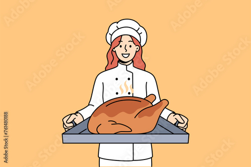 Woman cook with roast turkey on tray invites you to celebrate thanksgiving and eat meat together. Restaurant chef recommends celebrating thanksgiving by making traditional poultry dish.