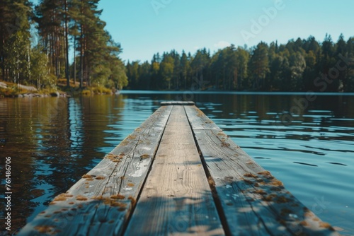 A long wooden dock on top of a serene lake. Perfect for travel and nature concepts
