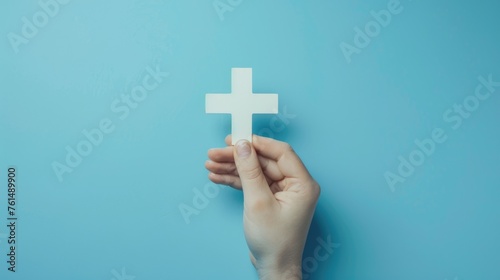 Person holding paper cross, suitable for religious concepts