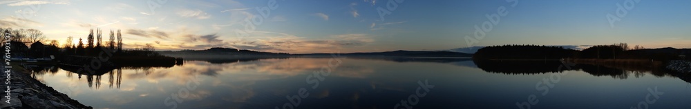 panorama picture of the sunrise over the lake with the reflection in the lake panorama picture of the sunrise over the lake with the reflection in the lake