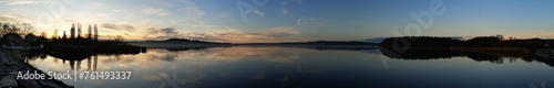 panorama picture of the sunrise over the lake with the reflection in the lake