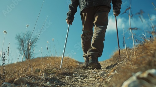 A man walking up a hill with ski poles. Suitable for outdoor and winter sports concepts
