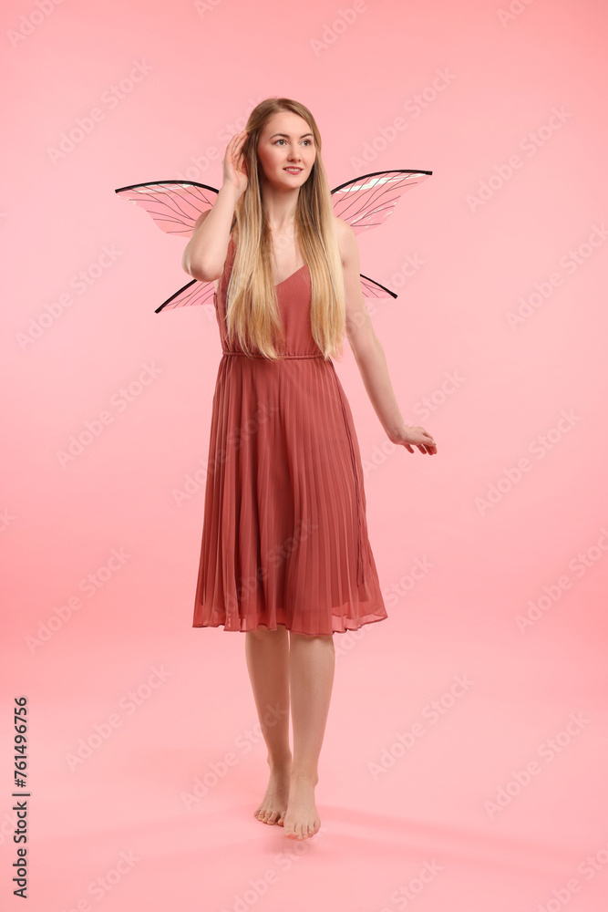Beautiful girl in fairy costume with wings on pink background Beautiful girl in fairy costume with wings on pink background