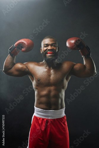 Vertical portrait of intimidating African American boxer screaming and wearing mouth guard photo