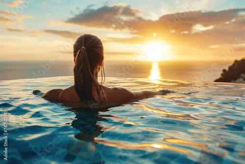 A woman relaxing in a swimming pool at sunset. Perfect for travel brochures or wellness magazines