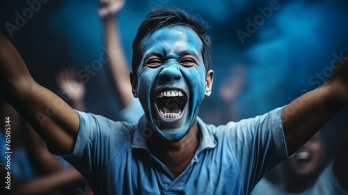 Enthusiastic fans in blue shirts cheering live match from stands in fan zone with fervor