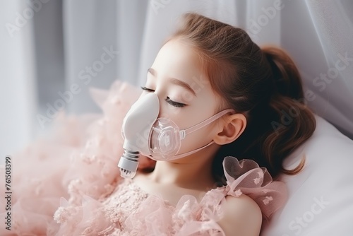 Young 5 year old girl in hospital bed with oxygen mask, recuperating from illness in medical ward photo