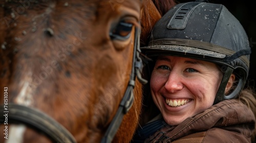 Happy woman wearing helmet embracing horse photo