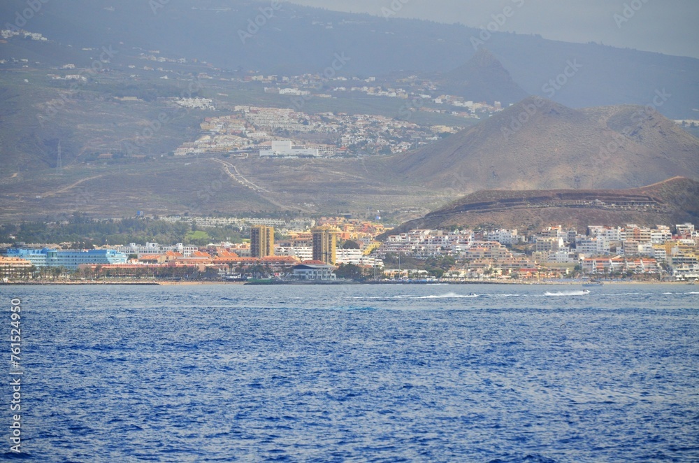 View on resorts and beaches of South coast of Tenerife island during sail boat trip along coastline, Canary islands, Spain in winter