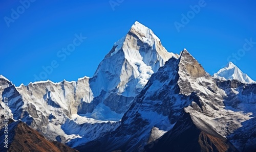 Mountain peaks covered in snow against a blue sky 