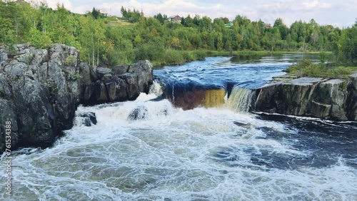 Voytsky padun waterfall in autumn. The famous powerful and wide Karelian waterfall Voytsky Padun is surrounded by rocks and greenery. Cascading waterfall on the river. Karelia, Russia 4K photo