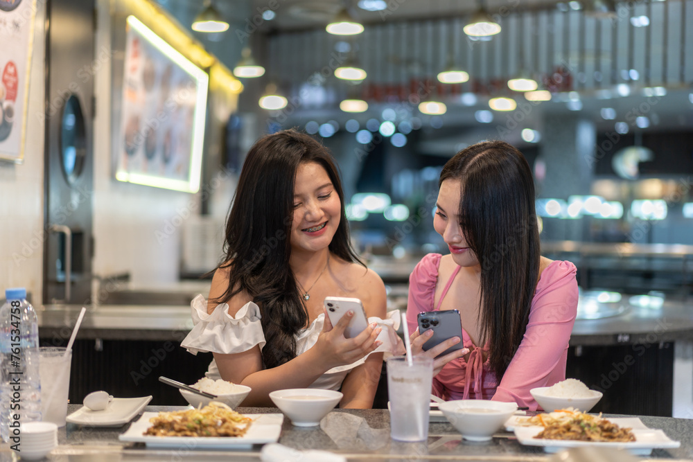 Two asian women selecting food , elegant restaurant, deeply engrossed in selecting meals from gourmet menu, lifestyle, leisure, luxury dining, female friendship, discussing sharing recommendation