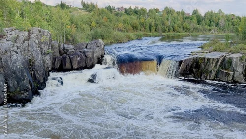 Voytsky padun waterfall in autumn. The famous powerful and wide Karelian waterfall Voytsky Padun is surrounded by rocks and greenery. Cascading waterfall on the river. Karelia, Russia 4K photo