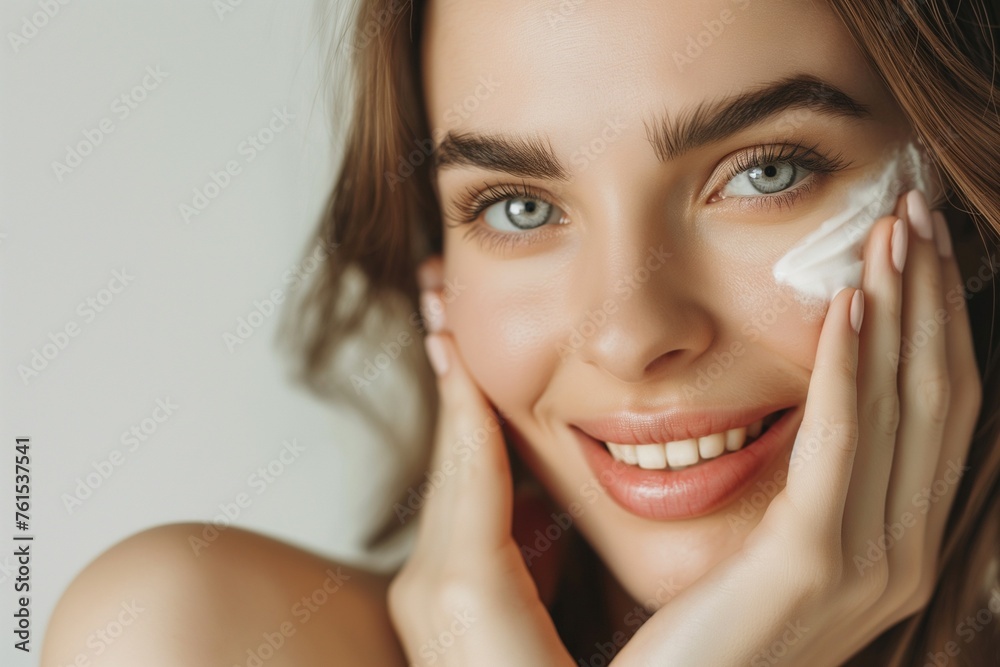 young woman hands applying cream to skin, close-up