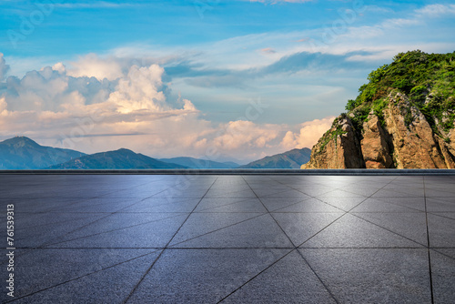 Empty square floor and mountain with sky clouds at sunset