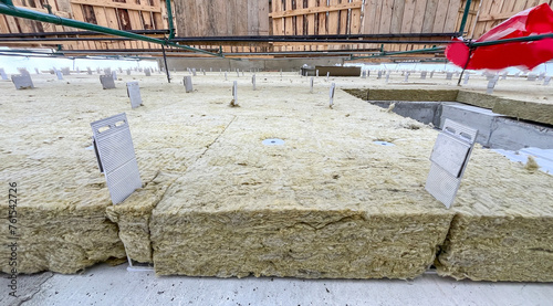 Fotografie Insulation of facade of building with stone mineral wool, installation of ventilated facade of new houses, Building external wall thermal insulation with mineral wool