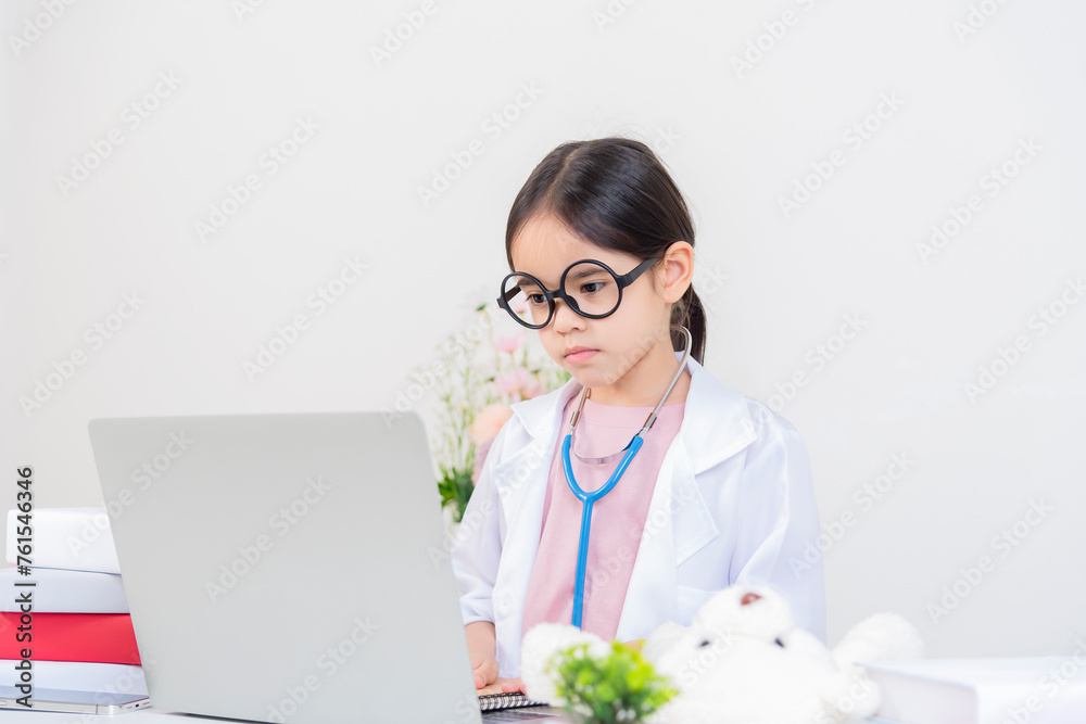 Doctor using laptop in office Cute little girl asian with stethoscope playing doctor Doctor using laptop in office Cute little girl asian with stethoscope playing doctor