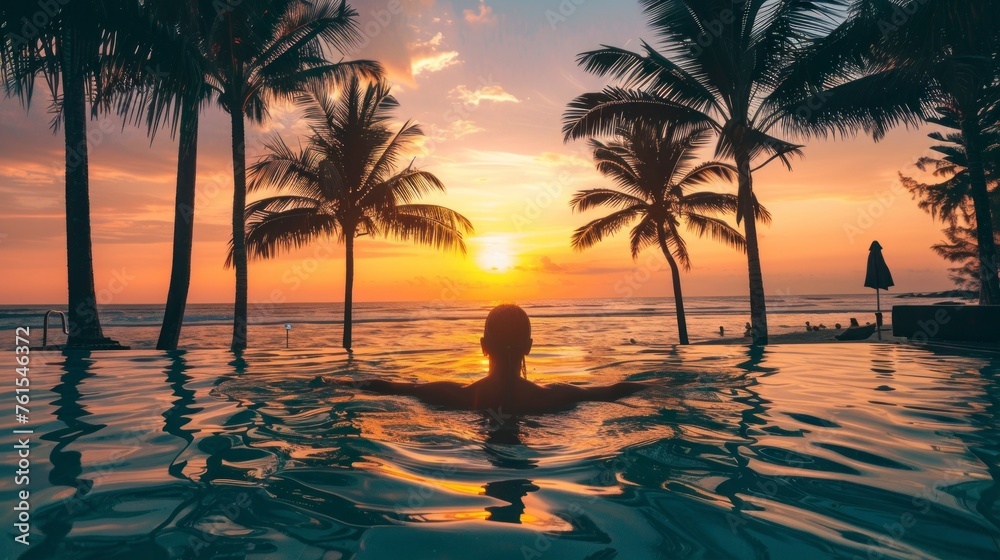 man lying in a pool on his back at a sunset on a beautiful paradise beach in high resolution