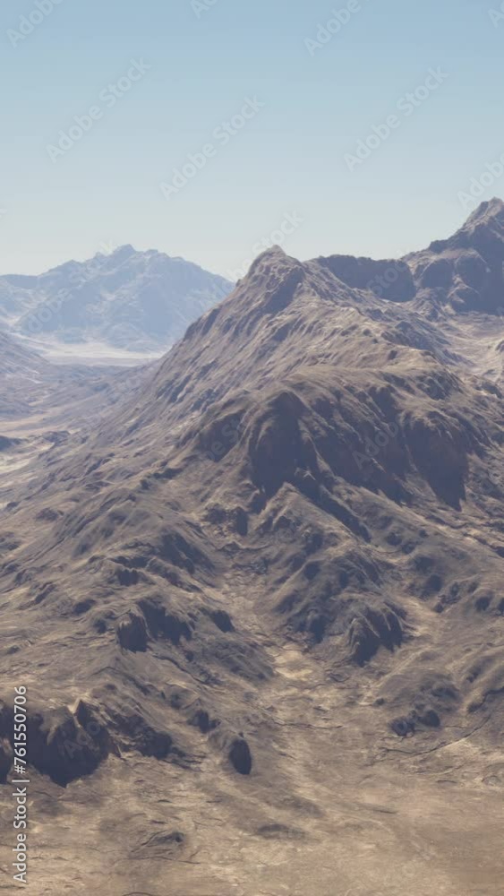 A breathtaking aerial view of majestic mountains in the vast desert landscape A breathtaking aerial view of majestic mountains in the vast desert landscape