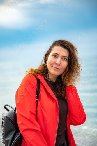 girl in a red jacket on the seashore © dbrus