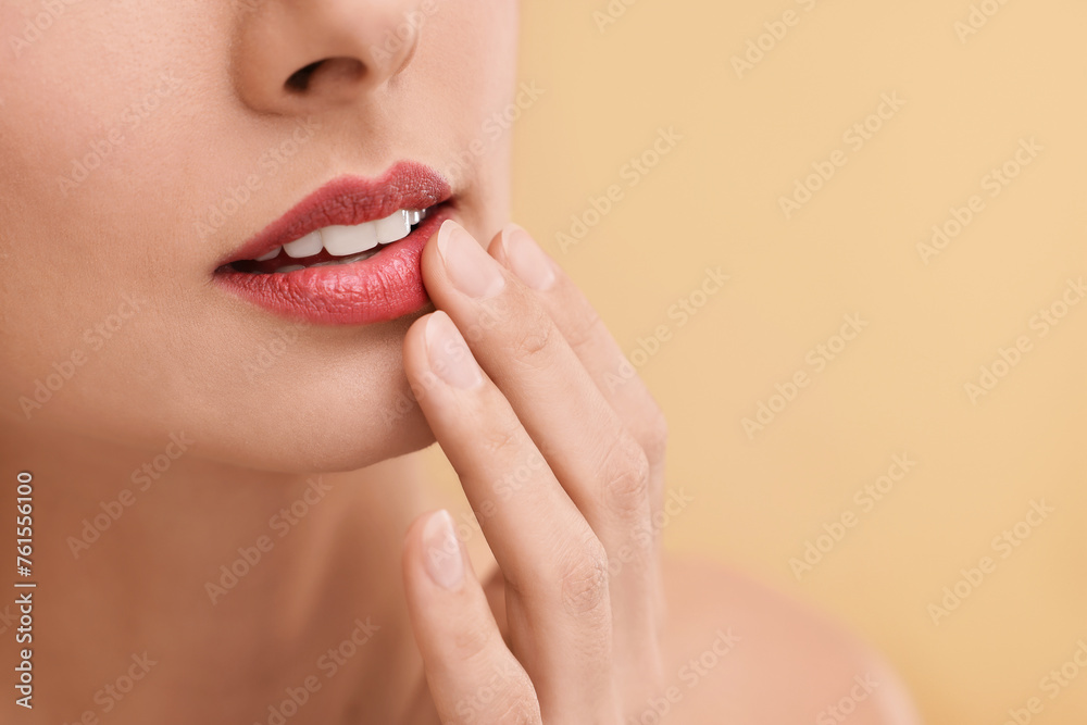 Woman with beautiful lips on beige background, closeup. Space for text Woman with beautiful lips on beige background, closeup. Space for text