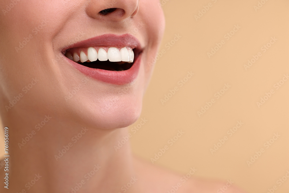 Obraz premium Woman with beautiful lips smiling on beige background, closeup. Space for text