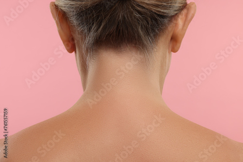 Mature woman with healthy skin on pink background, closeup