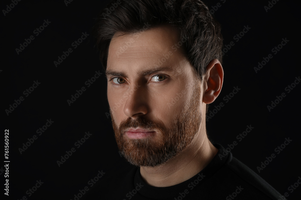 Evil eye. Man with scary eyes on black background, closeup Evil eye. Man with scary eyes on black background, closeup