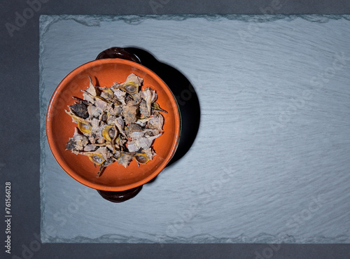 Bolinus brandaris or murici, Plate of seafood morsels with lemon, boiled sea snails, Mediterranean Food. photo