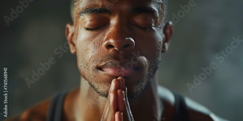 Young man holding his hands in prayer.