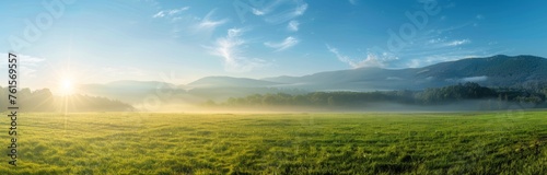 panoramic view of a foggy meadow with grass and trees in the background, mountains in the far distance, a blue sky, bright sun rays shining through the mist Generative AI