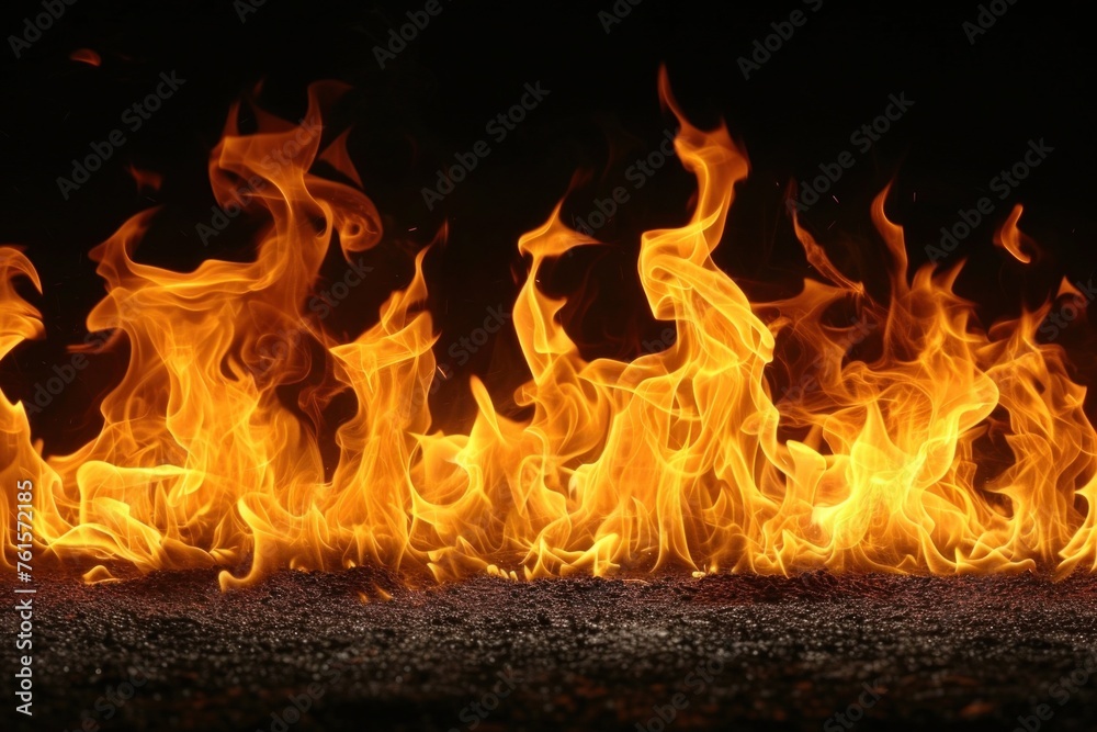 Fototapeta premium Intense Flames Rising Against a Dark Background, Capturing the Essence of Fire