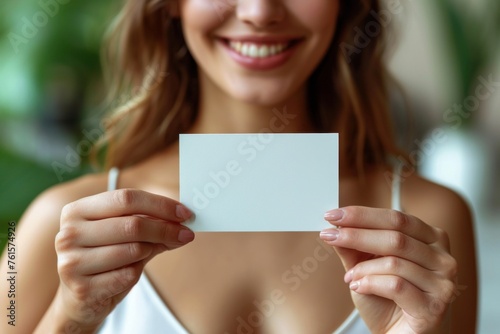 Young Woman Holding a Blank White Card in Front of Her Face Indoors During Daytime